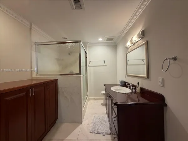 a bathroom with a sink a mirror and a shower