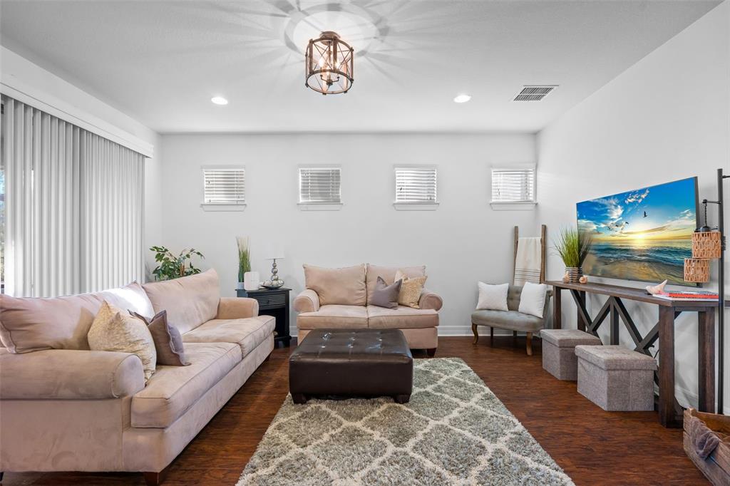 4730 111th Terrace East Parrish, FL 34219 - Photo 16 of 60 a living room with furniture and a flat screen tv