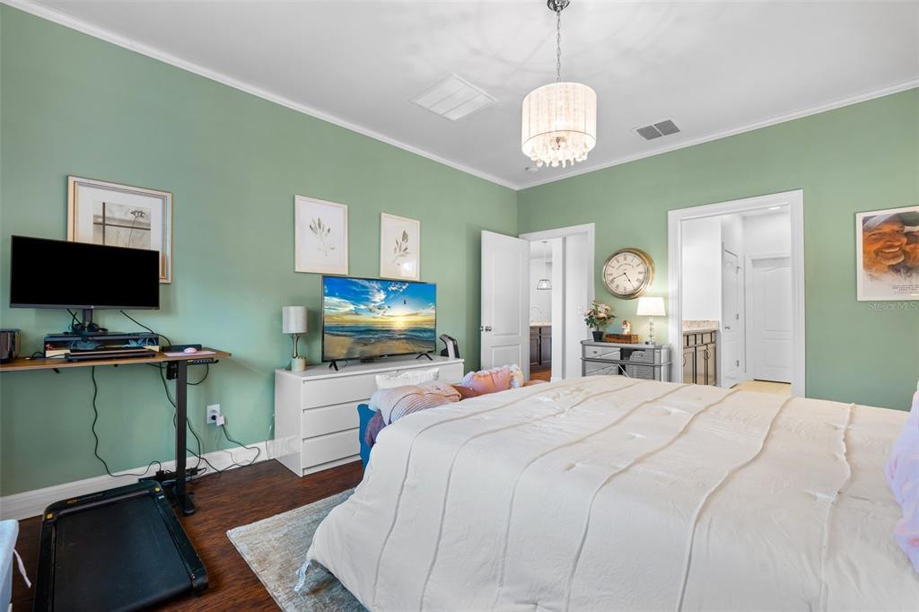 4730 111th Terrace East Parrish, FL 34219 - Photo 22 of 60 a bedroom with a bed and a flat screen tv