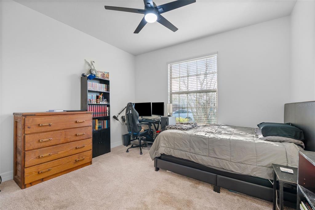 4730 111th Terrace East Parrish, FL 34219 - Photo 25 of 60 a bedroom with a bed and a window