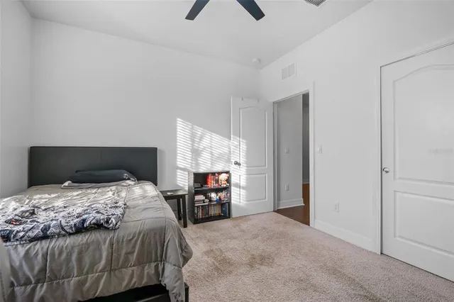 a spacious bedroom with a bed and a window