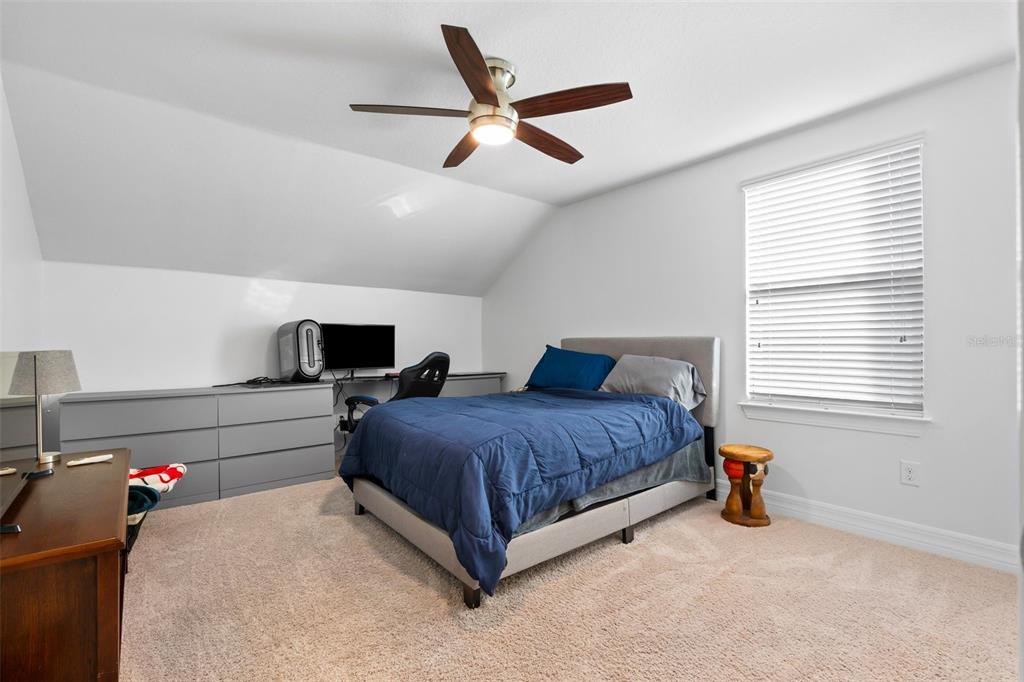 4730 111th Terrace East Parrish, FL 34219 - Photo 32 of 60 a spacious bedroom with a bed and a window