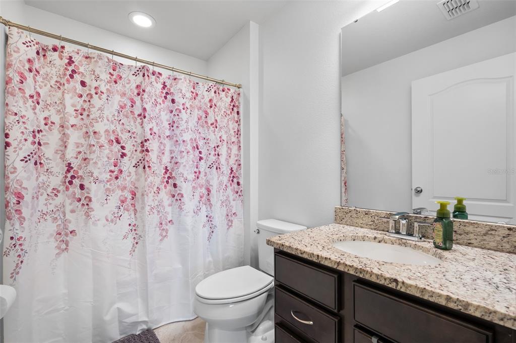 4730 111th Terrace East Parrish, FL 34219 - Photo 34 of 60 a bathroom with a granite countertop sink and a mirror