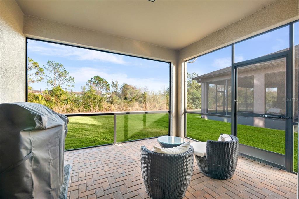 4730 111th Terrace East Parrish, FL 34219 - Photo 36 of 60 a view of a two chairs and table in patio with a garden