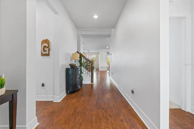 a kitchen with stainless steel appliances granite countertop a table chairs stove and microwave