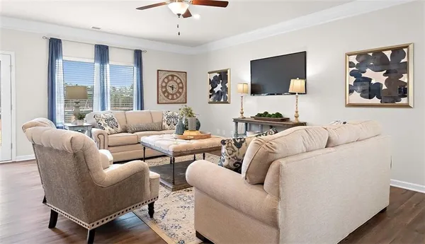 a living room with furniture and a flat screen tv