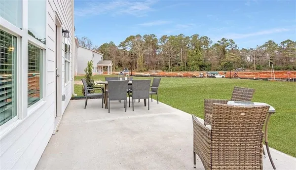 a view of a patio with a table chairs and a lake view