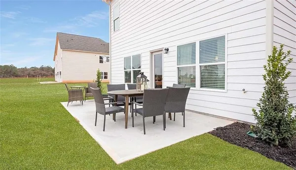 a view of a patio with table and chairs