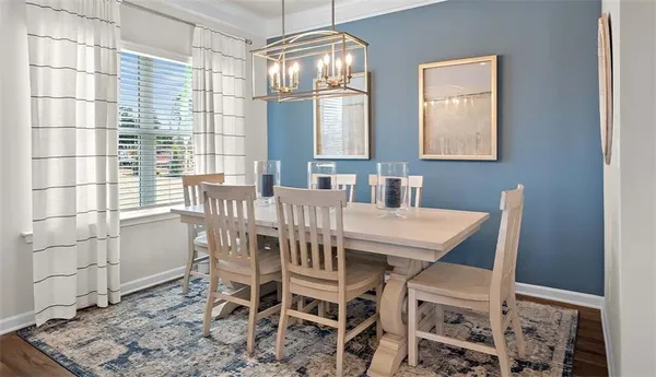 a view of a dining room with furniture and chandelier
