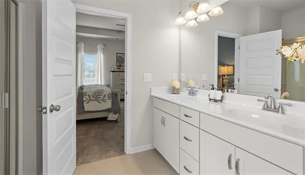 a en suite bathroom with a sink double vanity and a mirror