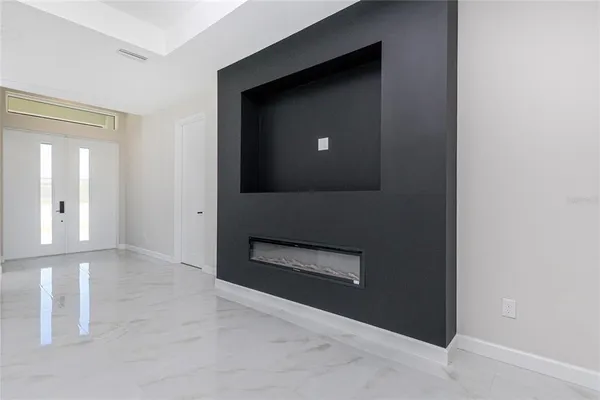 a view of a hallway with wooden floor and a cabinet