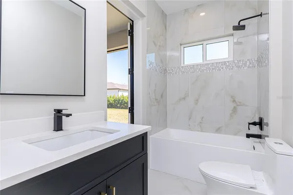 a bathroom with a sink a toilet and a bathtub