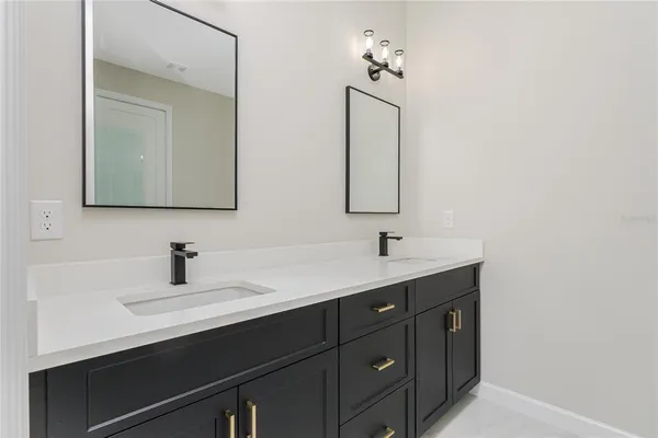 a bathroom with a double vanity sink and mirror