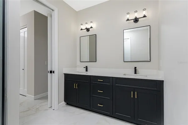 a bathroom with a double vanity sink and a mirror