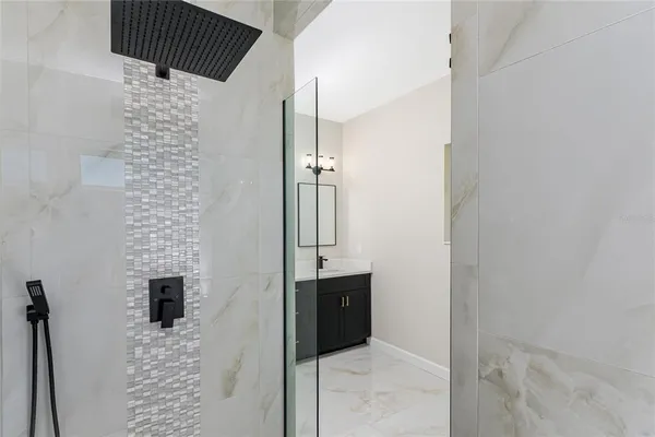 view of a bathroom with a shower and a sink