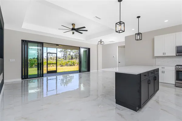 a view of a kitchen with a sink and a ceiling fan