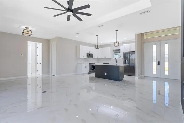 a large kitchen with stainless steel appliances a refrigerator and a cabinets