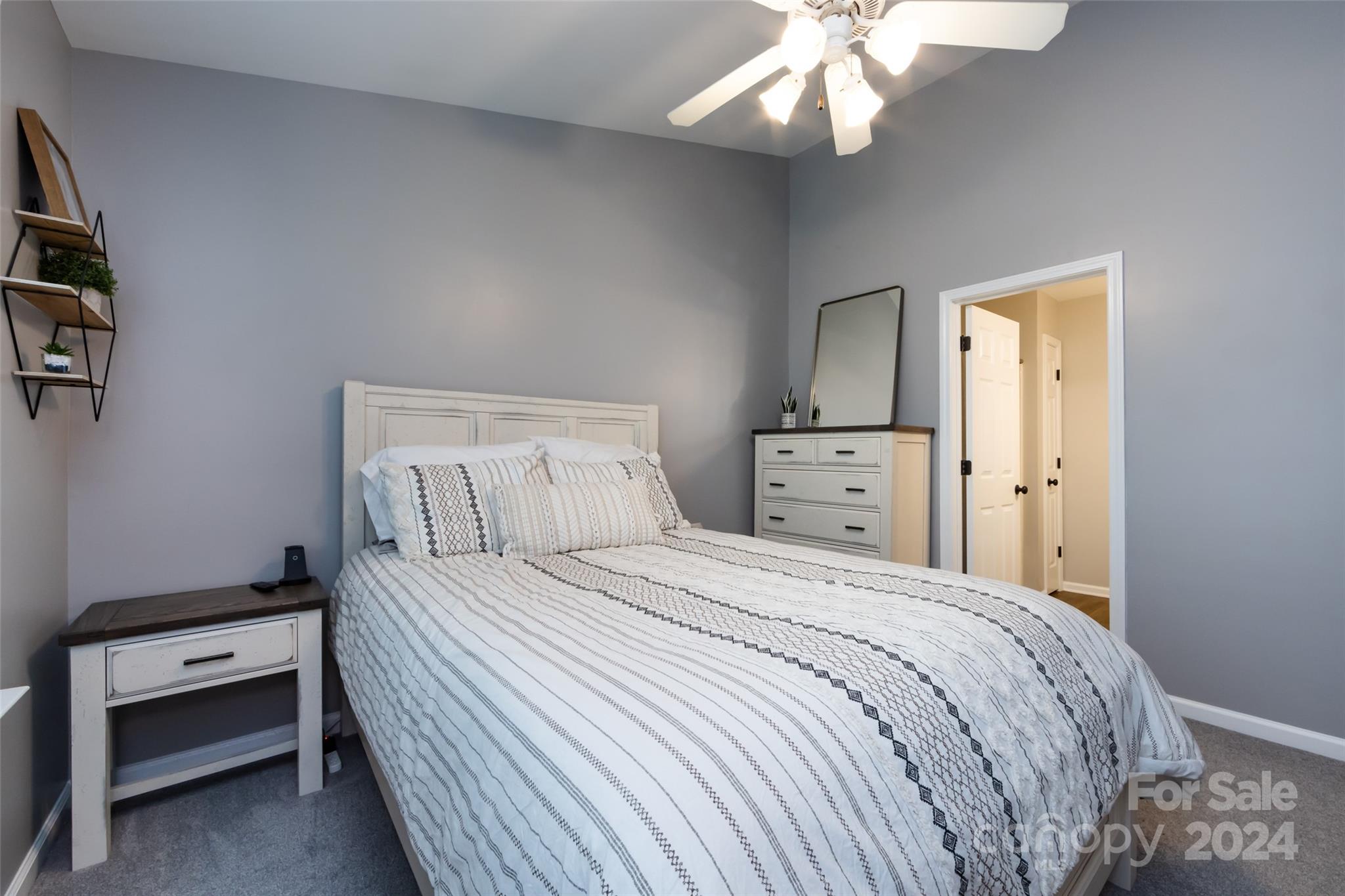 726 Shellstone Place Fort Mill, SC 29708 - Photo 20 of 31 a bedroom with a bed and a chandelier