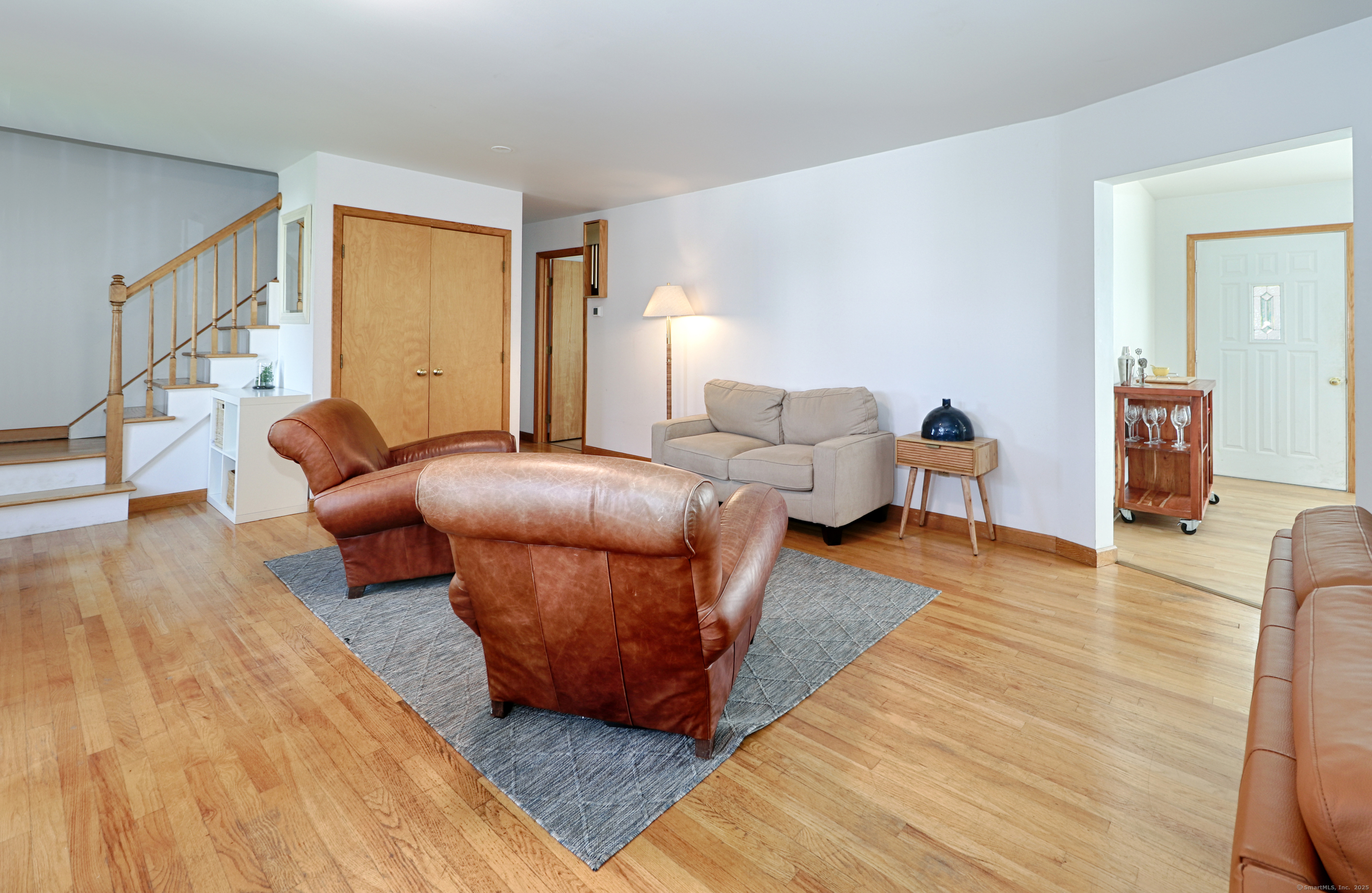 560 Fairfield Beach Road Fairfield, CT 06824 - Photo 11 of 38 a living room with furniture and a wooden floor