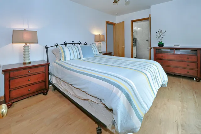 a bedroom with a bed and a night stand