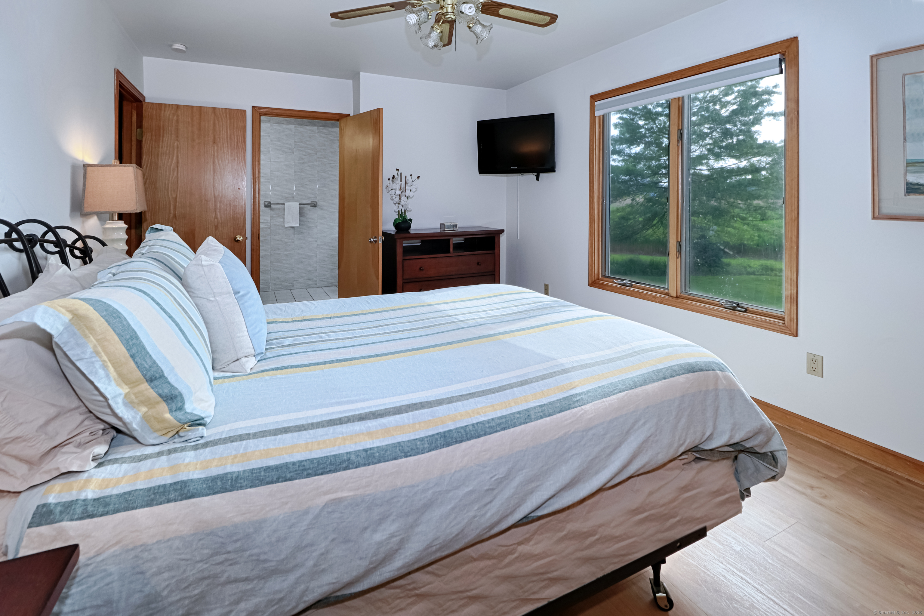 560 Fairfield Beach Road Fairfield, CT 06824 - Photo 14 of 38 a bedroom with a bed and a tv