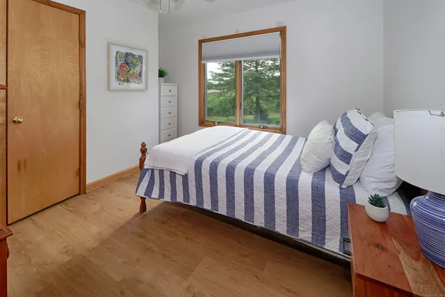 a bedroom with a bed and a window