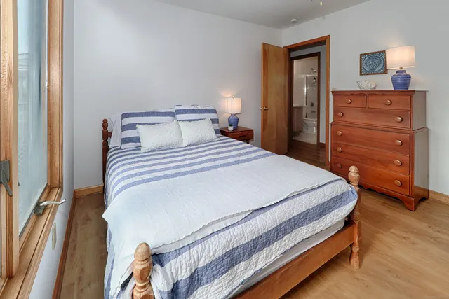 a bedroom with a bed and cabinet