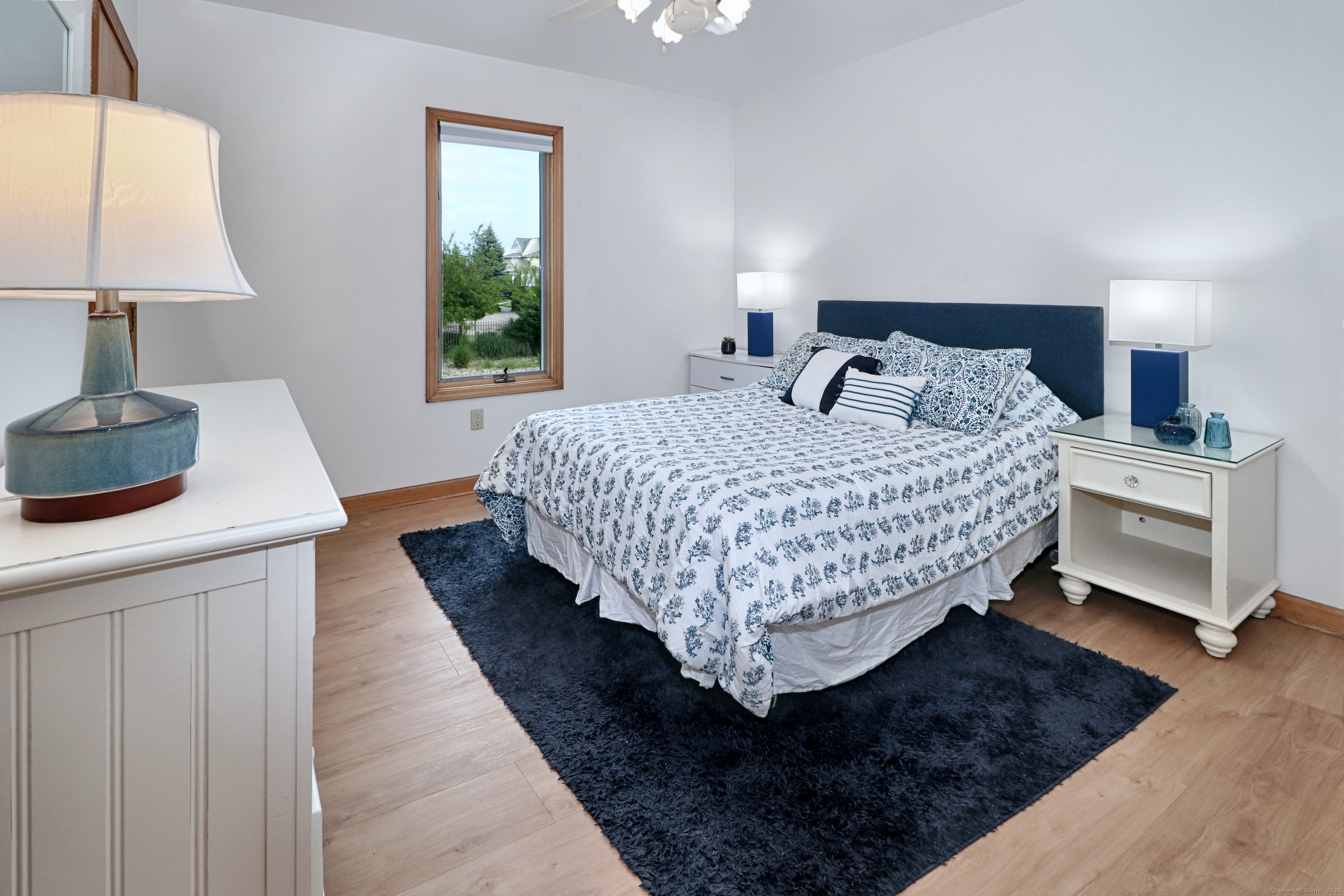 560 Fairfield Beach Road Fairfield, CT 06824 - Photo 17 of 38 a bedroom with bed and window