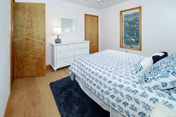 a bedroom with a bed and a dresser