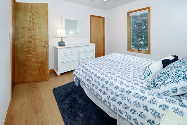 a bedroom with a bed and a dresser