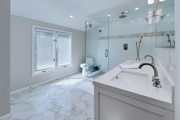 a bathroom with a sink a toilet and shower