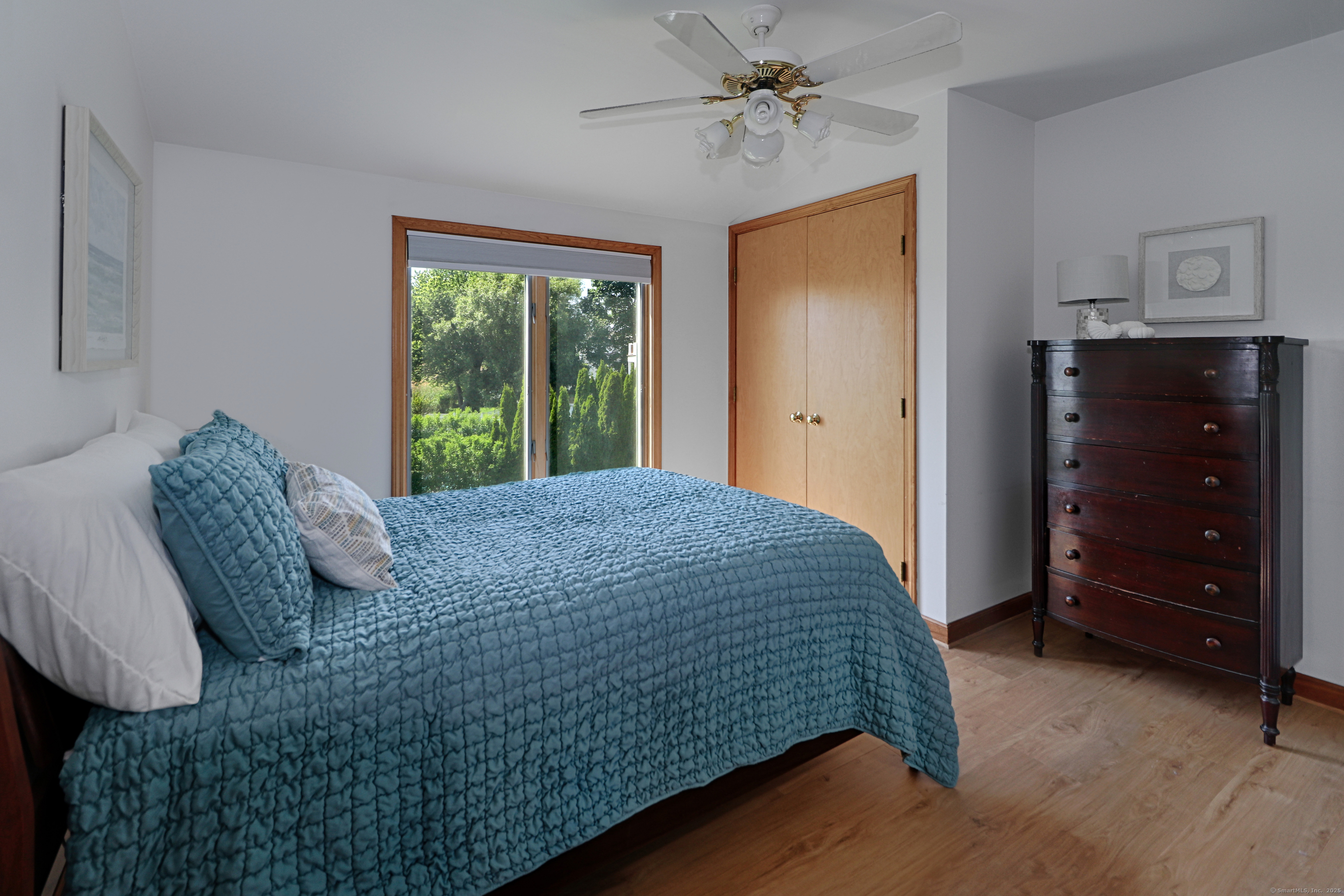 560 Fairfield Beach Road Fairfield, CT 06824 - Photo 25 of 38 a bedroom with a bed a dresser and a window