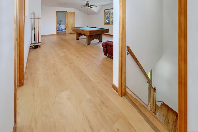 a view of a livingroom with wooden floor and furniture