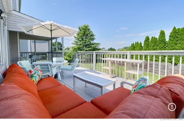 a view of a patio with couches under an umbrella