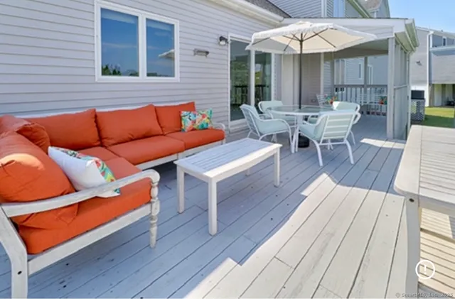 a outdoor space with patio the couches and a potted plant on a wooden floor