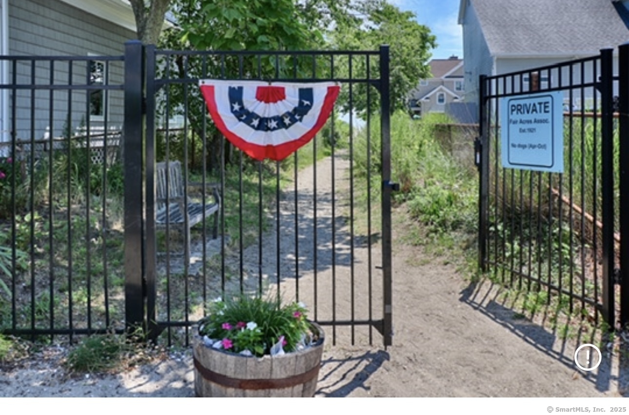 560 Fairfield Beach Road Fairfield, CT 06824 - Photo 33 of 38 a view of a sign board with a small yard and potted plants