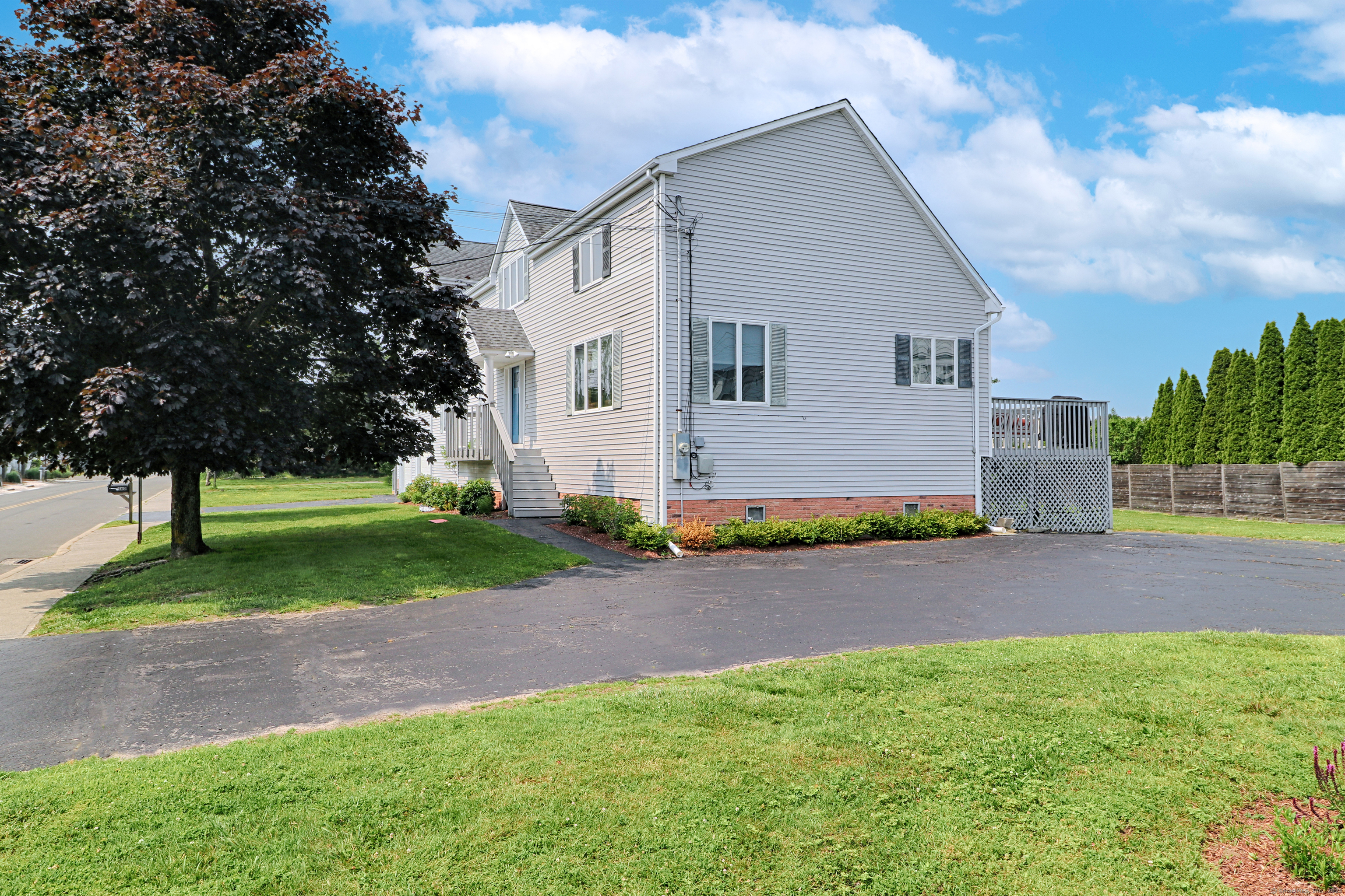 560 Fairfield Beach Road Fairfield, CT 06824 - Photo 36 of 38 a front view of house with yard and green space
