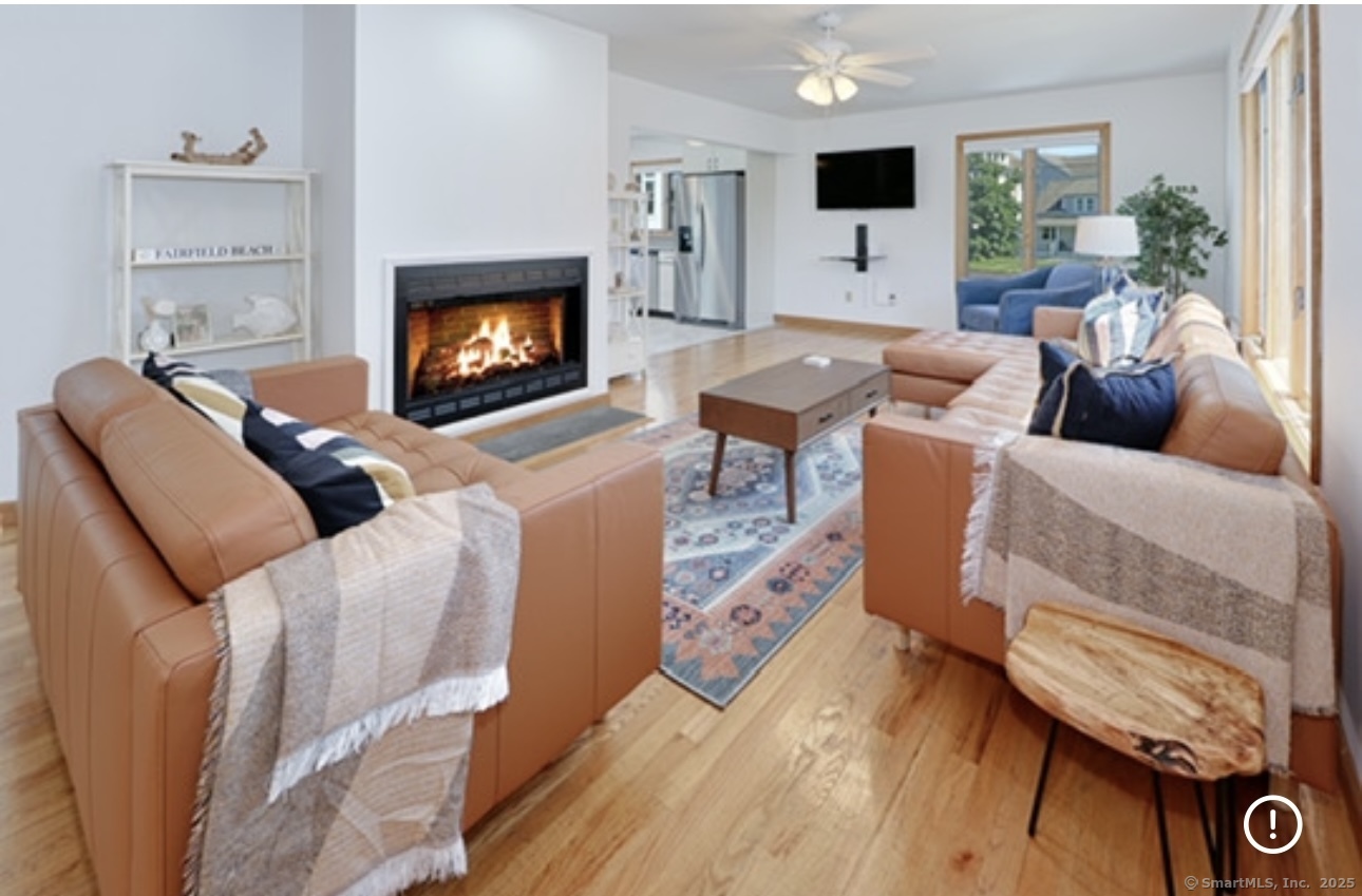 560 Fairfield Beach Road Fairfield, CT 06824 - Photo 8 of 38 a living room with furniture and a flat screen tv