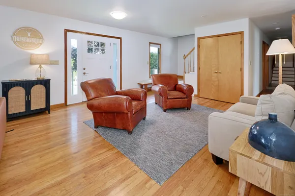 a living room with furniture and a wooden floor