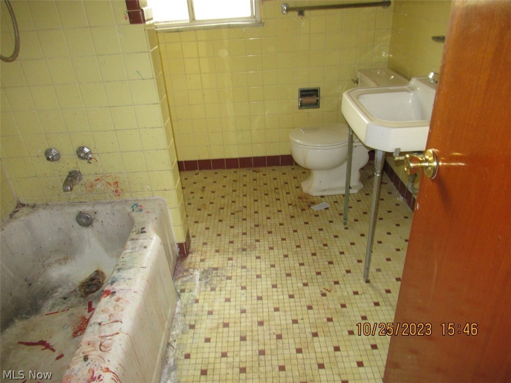 2360 Edgerton Road Cleveland, OH 44118 - Photo 9 of 9 Full bathroom featuring sink, tile walls, tiled shower / bath combo, toilet, and tile floors