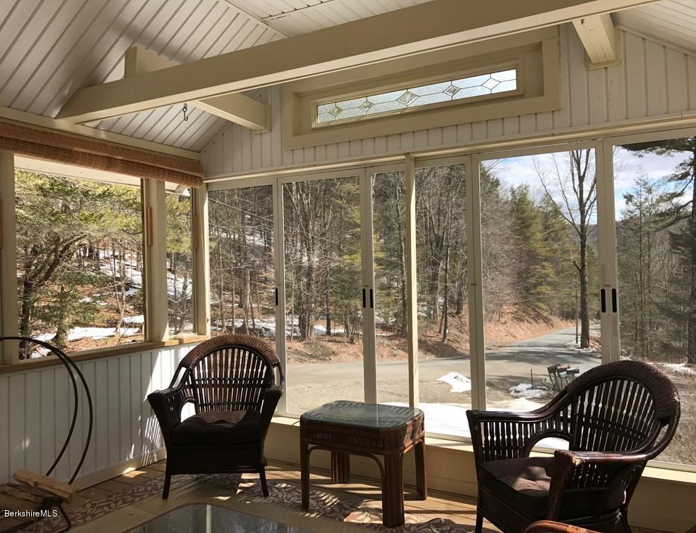 47 Thompson Road Colrain, MA 01340 - Photo 8 of 17 a living room with furniture and a floor to ceiling window