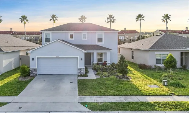 a front view of a house with a yard and garage