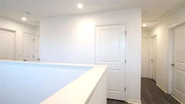 a view of a refrigerator a sink and a mirror