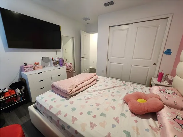 a bedroom with a bed and dresser
