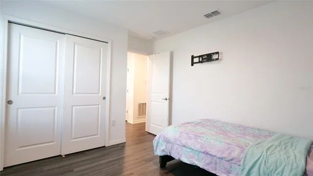 a bedroom with a bed and a chair