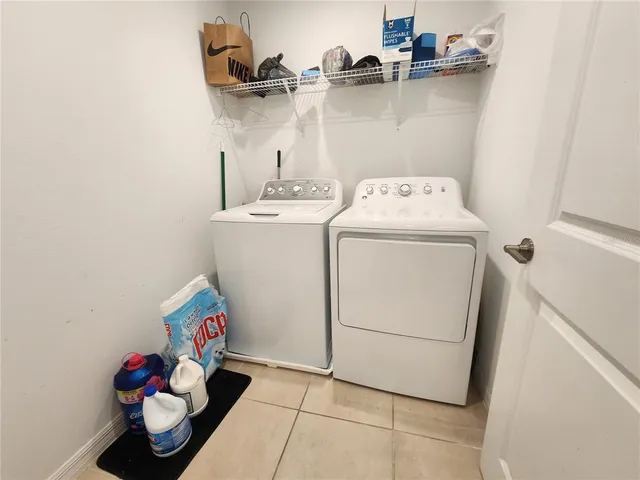 a bed room with a bed a flat screen tv and a window