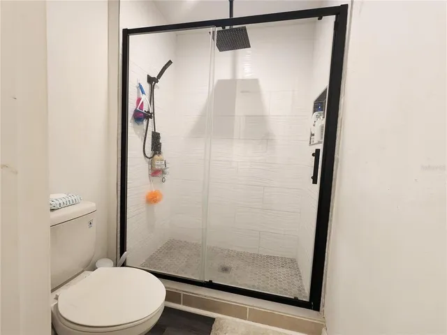 an aerial view of a house with a swimming pool outdoor seating and yard