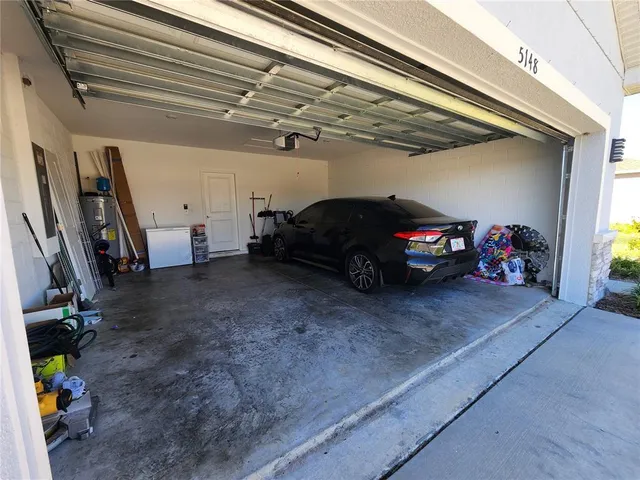 an aerial view of a house with a swimming pool and outdoor seating