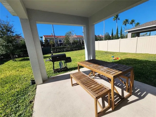 an aerial view of a house with a swimming pool and a yard