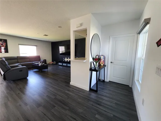 a bathroom with a toilet and a potted plant